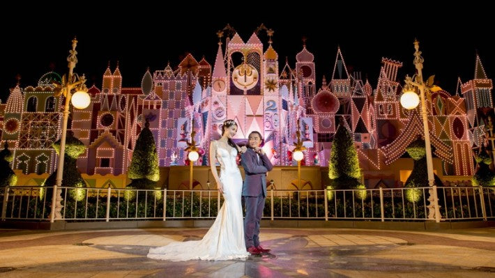 Leanne Li with her groom at a theme park 
