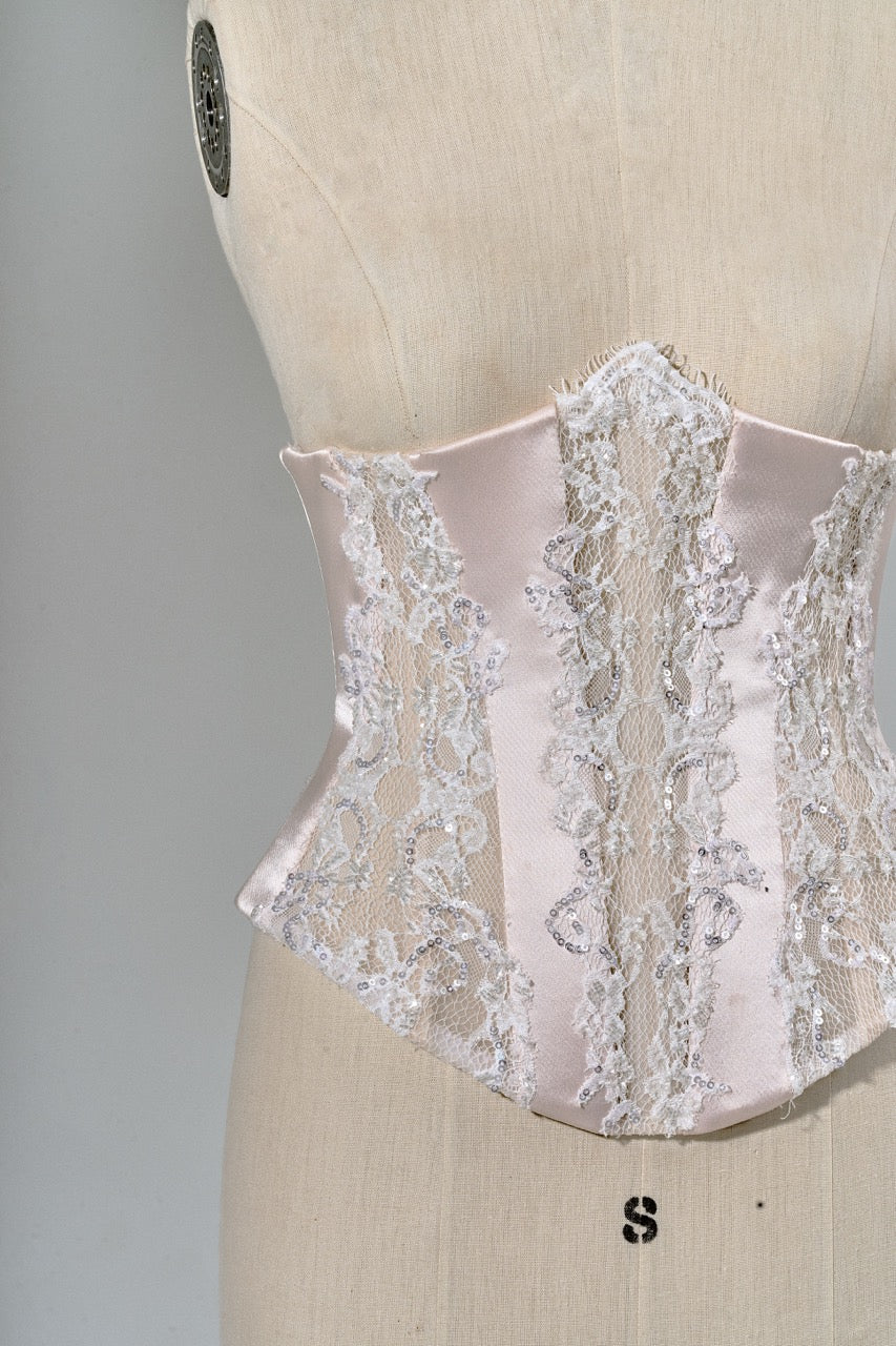 Lace corset on a mannequin against a neutral background