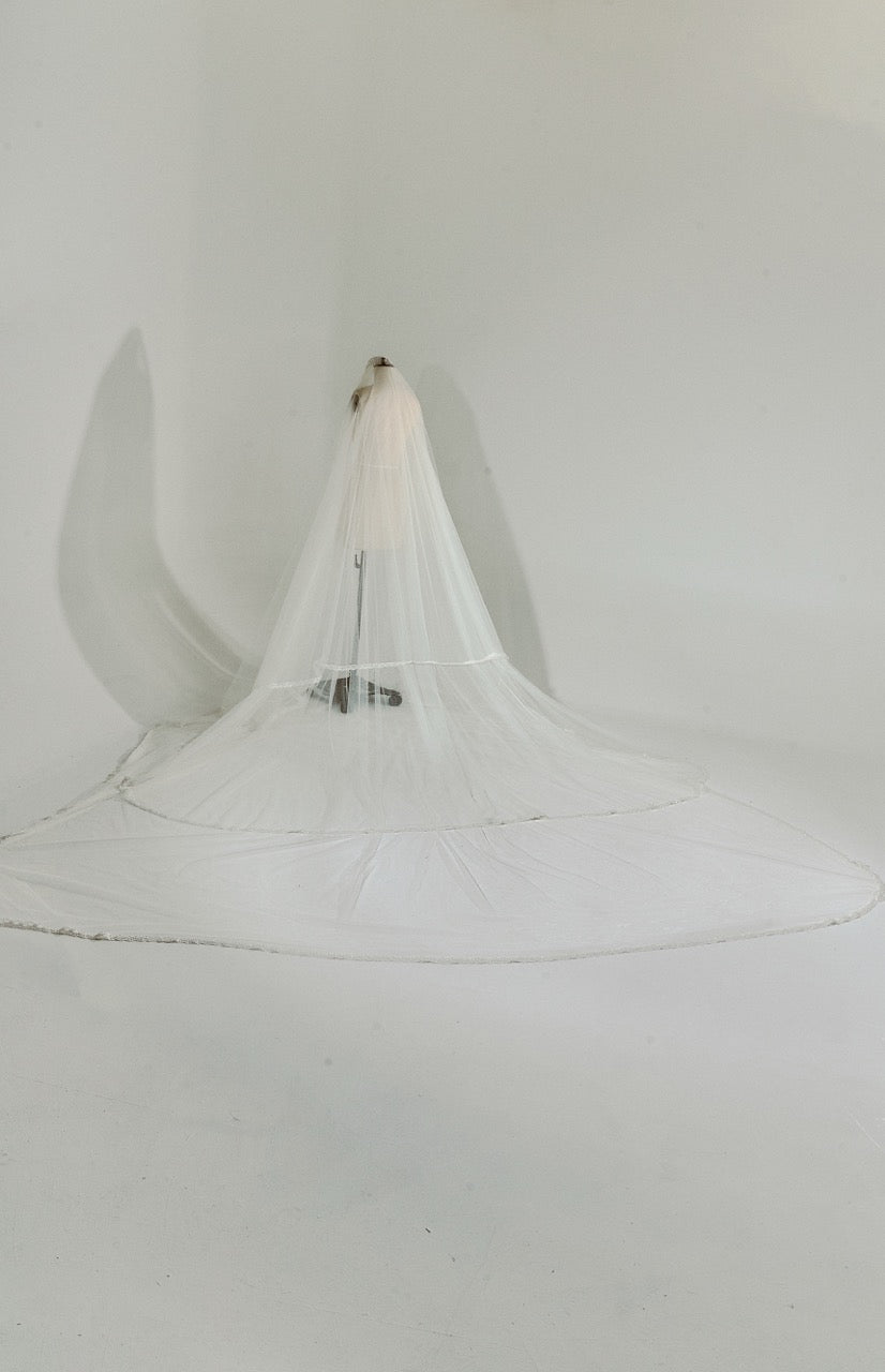 White wedding dress on a mannequin against a white background