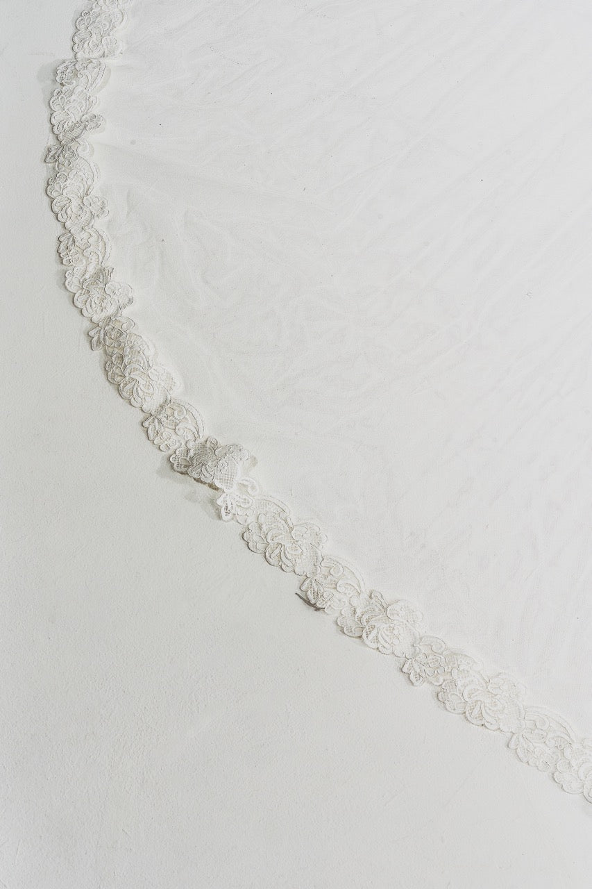 Silver chain necklace on a light gray background