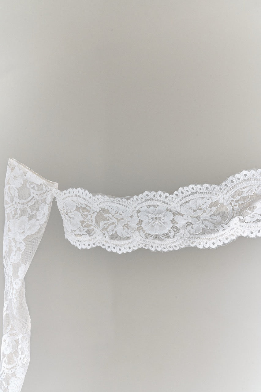 White lace trim on a gray background